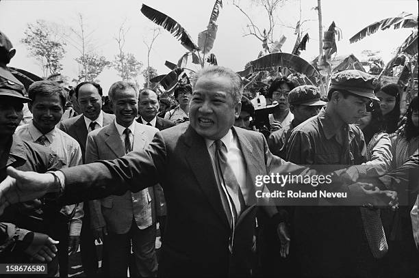 Prince Sihanouk is returning to Cambodia for the first time after being forced into exile by the Khmer Rouge in 1977. He is flanked by Khmer Rouge...