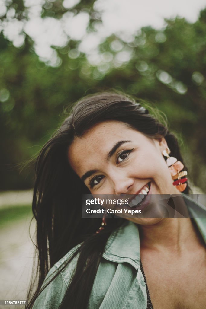 Simple low angle portrait of a young hispanic woman looking at the camera