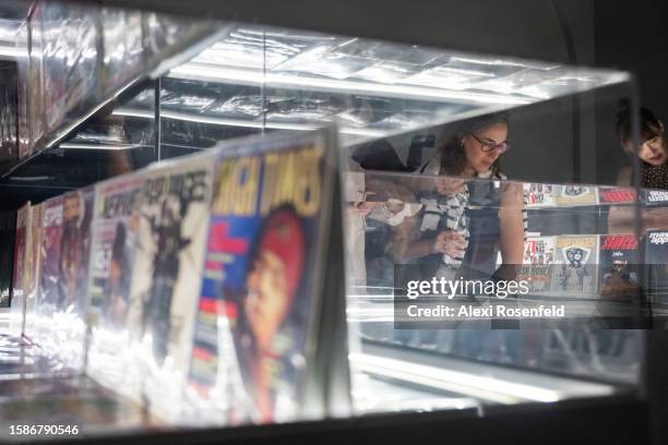 People take photos and look at New York City magazines collected by archivist Brian Nagata at the opening night preview of the new ‘Hip Hop Til...