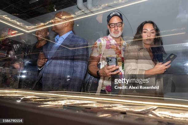 People take photos and look at New York City magazines collected by archivist Brian Nagata at the opening night preview of the new ‘Hip Hop Til...