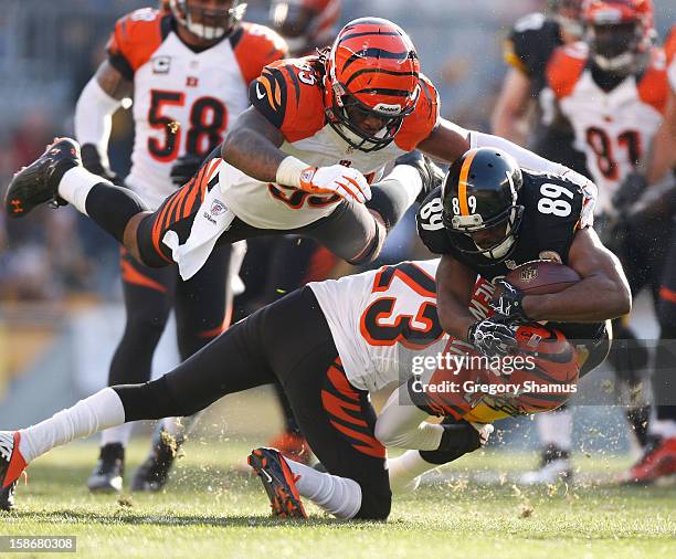 Jerricho Cotchery of the Pittsburgh Steelers is tackled by Terence Newman and Vontaze Burfict of the Cincinnati Bengals after a second quarter catch...