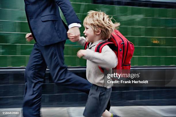 father and son running to school - enfant cartable photos et images de collection