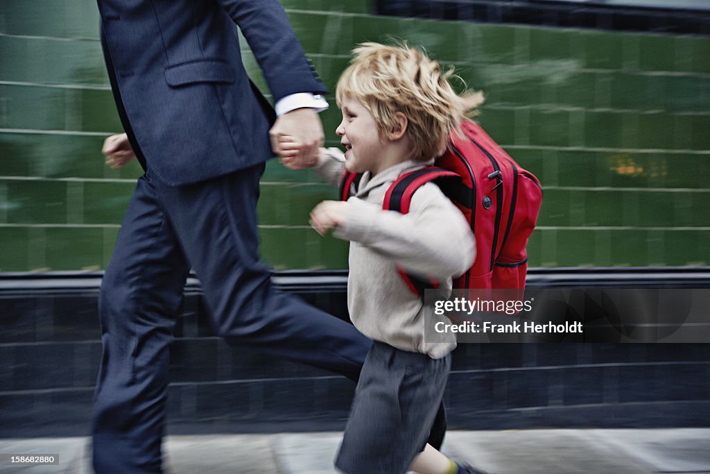 Father and son running to school