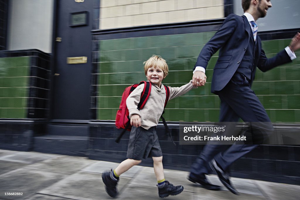 Father and son running to school