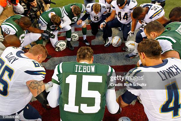 Quarterback Tim Tebow the New York Jets leads a players prayer after their game against the San Diego Chargers at MetLife Stadium on December 23,...