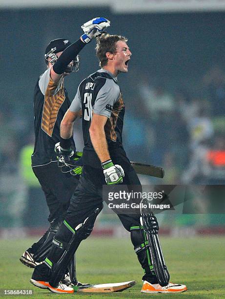 Martin Guptil of New Zealand celebrates his 100 with Colin Munro off the last ball to win the match during the 2nd T20 match between South Africa and...