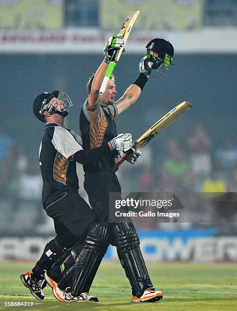 Martin Guptil of New Zealand celebrates his 100 with Colin Munro off the last ball to win the match during the 2nd T20 match between South Africa and...