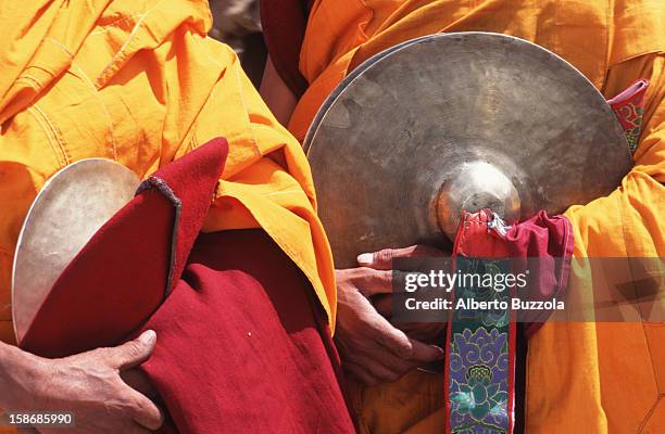 Monks holding cymbals for the religious ceremony that celebrates the struggle of good over evil..