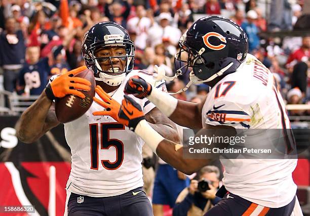 Wide receiver Brandon Marshall of the Chicago Bears celebrates with wide receiver Alshon Jeffery after a 11 yard touchdown reception against the...