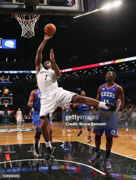 Joe Johnson of the Brooklyn Nets goes up and scores two against the Philadelphia 76ers at Barclays Center on December 23, 2012 in the Brooklyn...