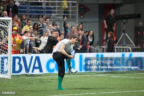 Iker Casillas remove his sport shoes after 'Partido X La Ilusion' by Iker Casillas Foundation at Palacio de los Deportes on December 23, 2012 in...