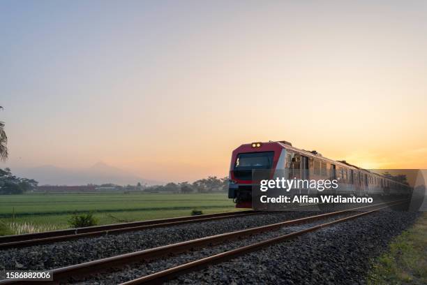 train passing through countryside - passenger train stock pictures, royalty-free photos & images