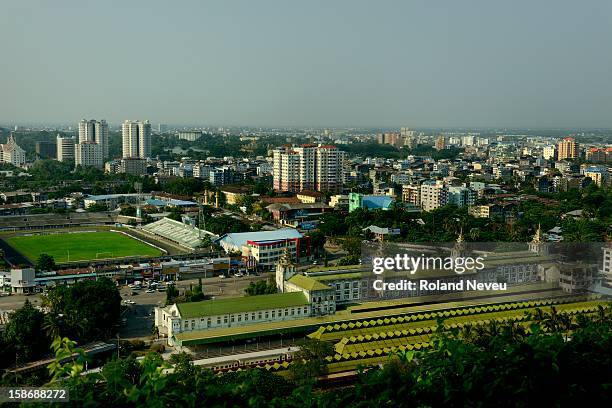 Views of downtown old Yangon from a tall building next to the Railway Station at the foreground, next to the Aung San stadium..