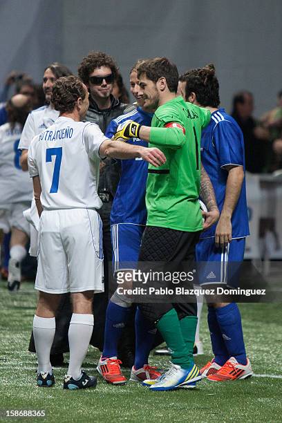 Emilio Butragueno, Guti and Iker Casillas embrace each other during 'Partido X La Ilusion' by Iker Casillas Foundation at Palacio de los Deportes on...