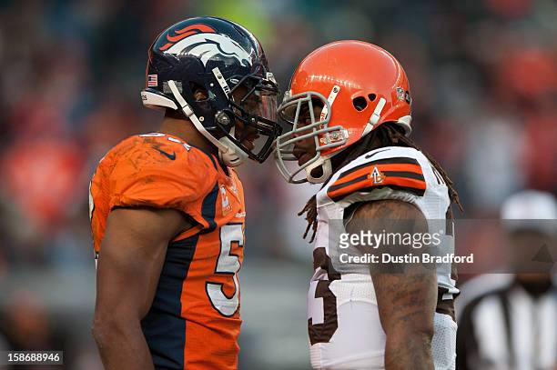Outside linebacker Wesley Woodyard of the Denver Broncos and running back Trent Richardson of the Cleveland Browns exchange words after a play during...
