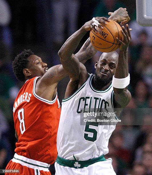 Boston Celtics power forward Kevin Garnett outmuscles Milwaukee Bucks center Larry Sanders for the ball during the first half as the Celtics play the...