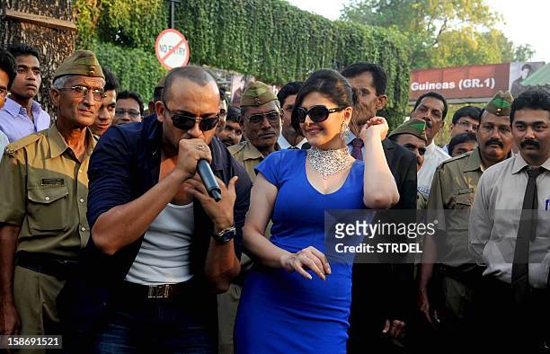 Indian Bollywood actress Zarine Khan poses with pop singer Ali Quli Mirza as she attends 'The Gitanjali Derby' at a racecourse in Mumbai on December...