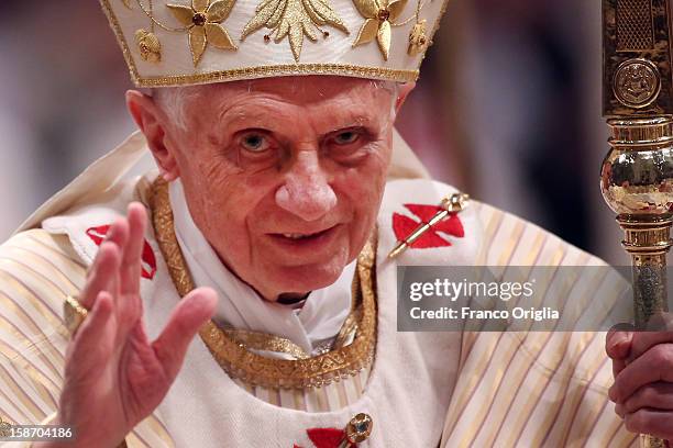 Pope Benedict XVI waves to the faithfuls as he leaves St. Peter's Basilica at the end of the Christmas night mass on December 24, 2012 in Vatican...