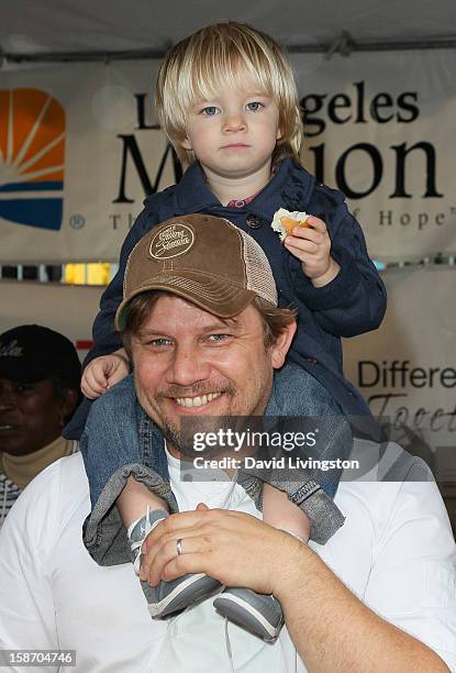 Chef Ben Ford and son attend the Los Angeles Mission's Christmas Eve for the homeless at the Los Angeles Mission on December 24, 2012 in Los Angeles,...