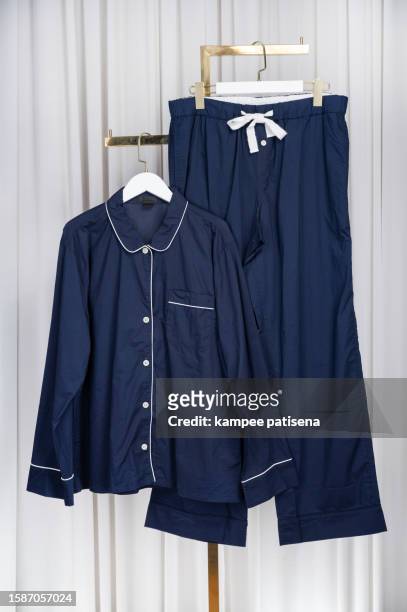 cozy pajamas displayed on clothes rack - silk garment stock pictures, royalty-free photos & images