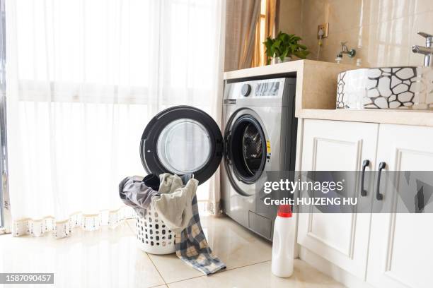 asian man using washing machine at home. laundry day - buanderie photos et images de collection
