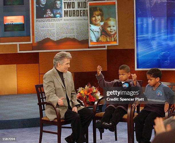 Television host John Walsh of the NBC show "The John Walsh Show" walks on stage with Jordan and Elijah, two children who were victims in a 1995...