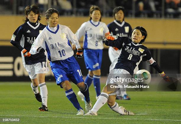 Homare Sawa and Hikaru Naomoto compete for the ball during the Great East Japan Earthquake charity match 'SAWA and Friends, X'mas Night 2012' at the...