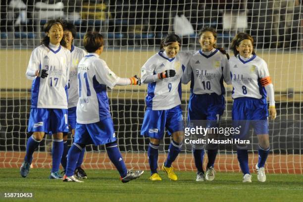 Homare Sawa celebrates her goal with team-mates during the Great East Japan Earthquake charity match 'SAWA and Friends, X'mas Night 2012' at the...