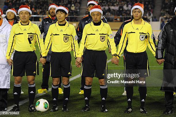 Match officials wear Christmas hats as they look on prior to the Great East Japan Earthquake charity match 'SAWA and Friends, X'mas Night 2012' at...