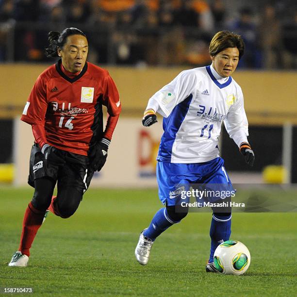 Tsuyoshi Kitazawa and Shinobu Ohno in action during the Great East Japan Earthquake charity match 'SAWA and Friends, X'mas Night 2012' at the...