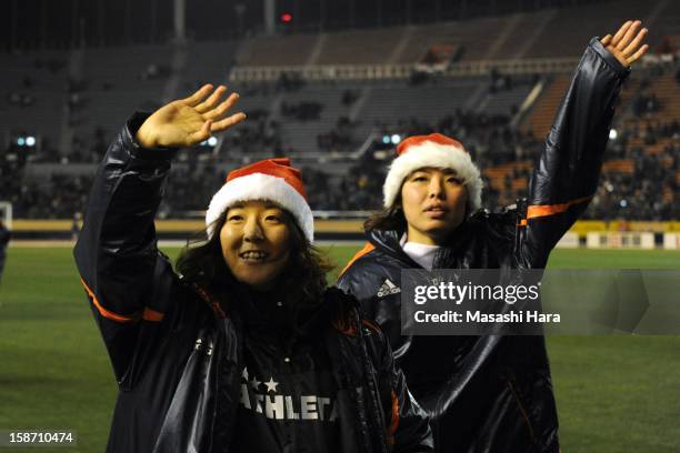 Yuki Ogimi and Saki Kumagai acknowledge spectators after the Great East Japan Earthquake charity match 'SAWA and Friends, X'mas Night 2012' at the...