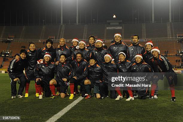 Players pose for photograph after the Great East Japan Earthquake charity match 'SAWA and Friends, X'mas Night 2012' at the National Stadium on...