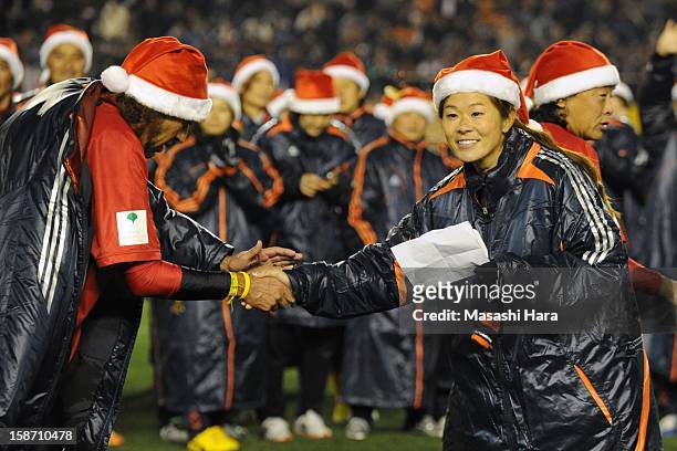 Homare Sawa and Rui Ramos shake hands after the Great East Japan Earthquake charity match 'SAWA and Friends, X'mas Night 2012' at the National...