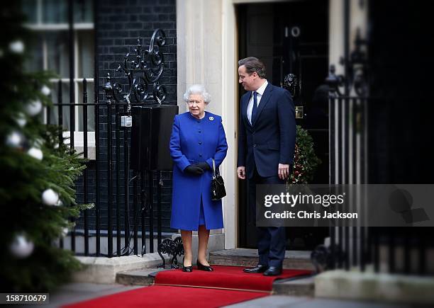 Queen Elizabeth II is greeted by Prime Minister David Cameron as she arrives at Number 10 Downing Street to attend the Government's weekly Cabinet...