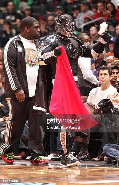 The Brooklyn Knight of the Brooklyn Nets distributes gifts to fans during the game against the Boston Celtics on December 25, 2012 at the Barclays...