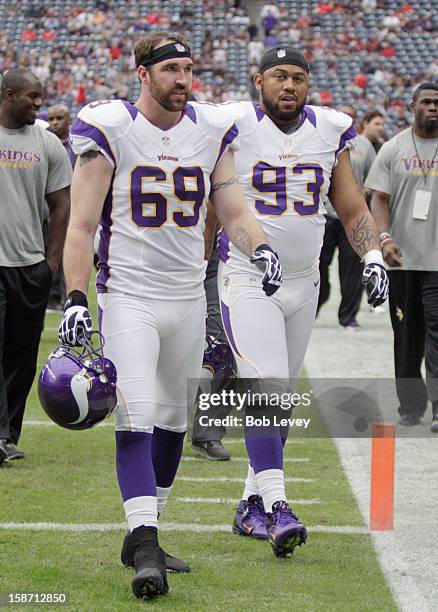 Jared Allen of the Minnesota Vikings and Kevin Williams walks off the field after pre-game warm ups before plaaying against the Houston Texans at...