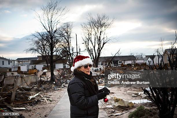 Volunteer who would only identify herself as "Nancy" helps decorate a Christmas Tree December 25, 2012 in the Breezy Point neighborhood of the Queens...