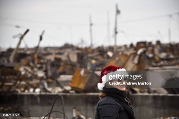 Volunteer who would only identify herself as "Nancy" steps back after helping decorate a Christmas Tree December 25, 2012 in the Breezy Point...