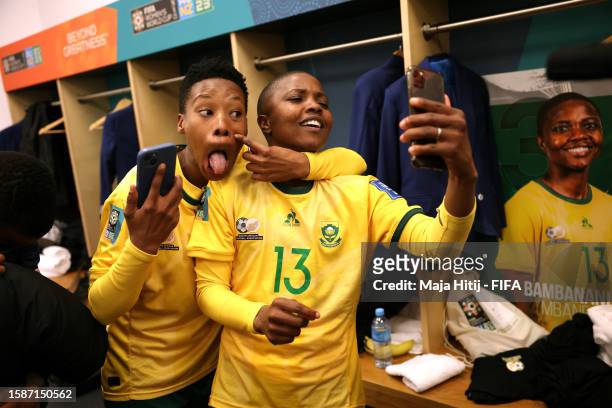 Melinda Kgadiete and Bambanani Mbane of South Africa celebrate in the dressing room after their team advanced to the knockouts during the FIFA...