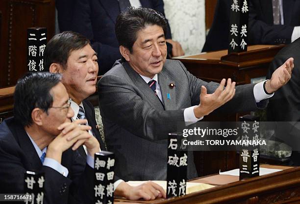 Shinzo Abe chats with Secretary General of the Liberal Democratic Party Shigeru Ishiba and former Chief Cabinet Secretary Hiroyuki Hosoda before...