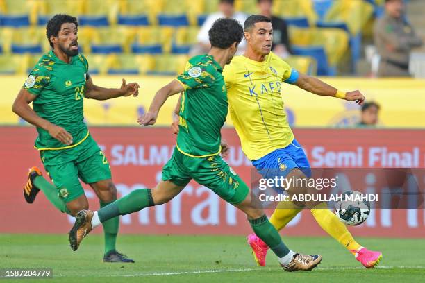 Nassr's Portuguese forward Cristiano Ronaldo vies for the ball during the 2023 Arab Club Champions Cup semi-final football match between Saudi...