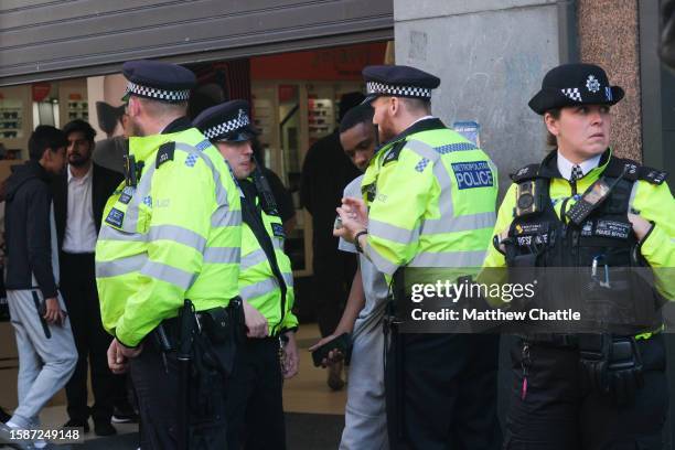 Police outside McDonald's on Oxford Street near to JD Sports where an alleged mass crime was due to take place.