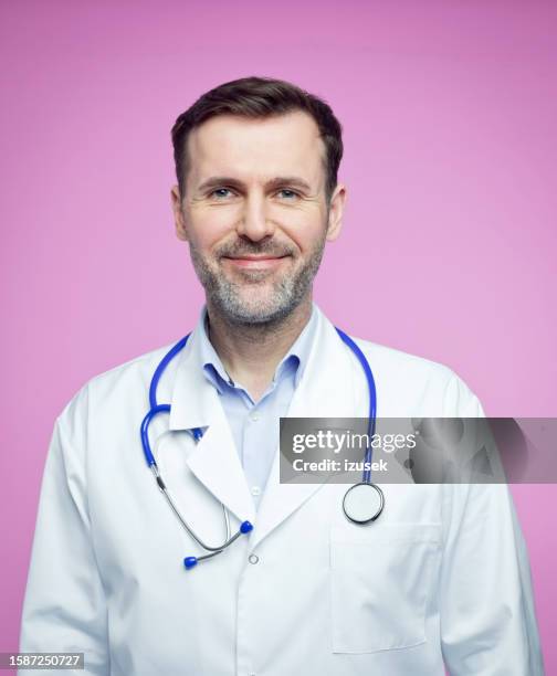 portrait of confident male doctor - medicare form stock pictures, royalty-free photos & images