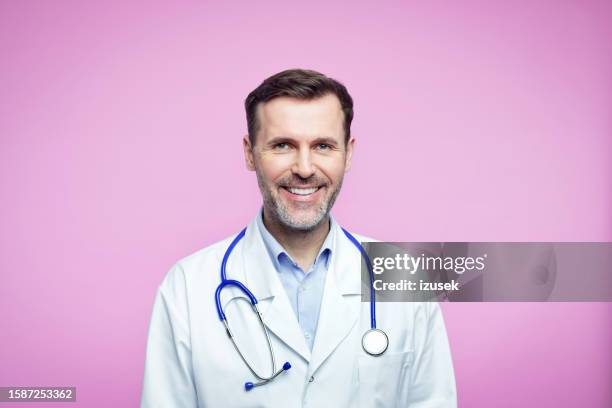 portrait of pleased male doctor - stubble stock pictures, royalty-free photos & images