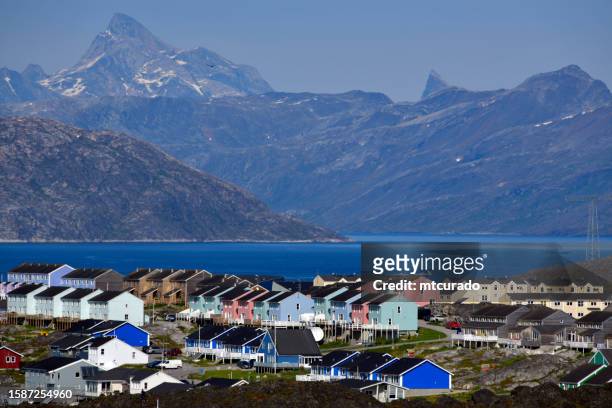 nuuk in summer - colorful houses facing the fjord with mountains in the horizon, nuuk, greenland - nuuk greenland stock pictures, royalty-free photos & images