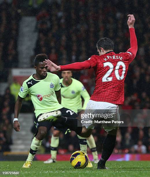 Robin van Persie of Manchester United in action with Gael Bigirimana of Newcastle United during the Barclays Premier League match between Manchester...