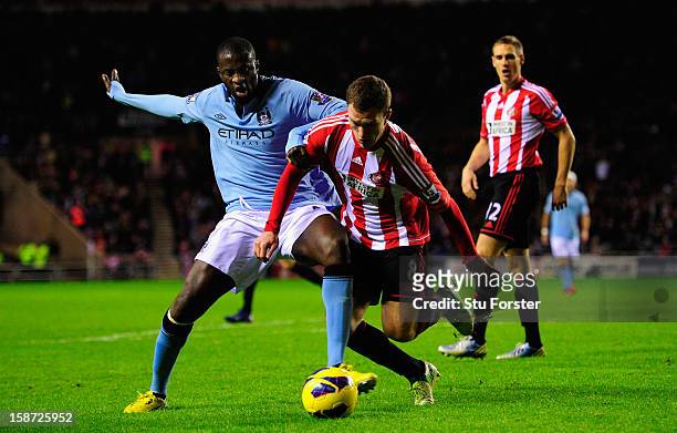 Sunderland defender Craig Gardner battles with Yaya Toure for the ball during the Barclays Premier League match between Sunderland and Manchester...