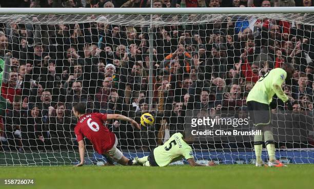 Jonny Evans of Manchester United scores his teams first goal during the Barclays Premier League match between Manchester United and Newcastle United...