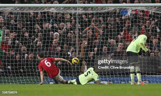 Jonny Evans of Manchester United scores his teams first goal during the Barclays Premier League match between Manchester United and Newcastle United...