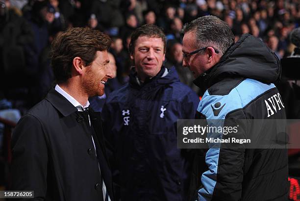 Andre Villas-Boas , manager of Tottenham Hotspur talks to Paul Lambert , manager of Aston Villa with his assistant Steffen Freund during the Barclays...